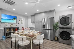 a kitchen and dining room with a table and chairs at Entire Private Home with Yard, King Bed, Prime Location, 3 Bedrooms 3 Bathrooms, Available Now in San Diego