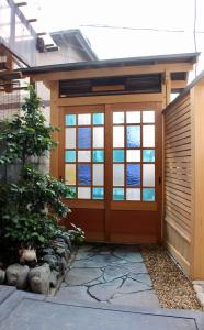 a garage with a door with stained glass at Jizo House in Kyoto
