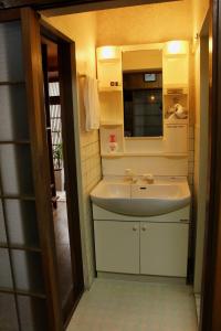a bathroom with a sink and a mirror at Jizo House in Kyoto