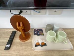 a tray with cups and other items on a table at Hai Jing Man Lu B&B in An-hsia