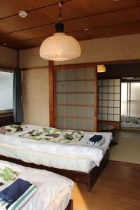 Ένα ή περισσότερα κρεβάτια σε δωμάτιο στο Jizo House
