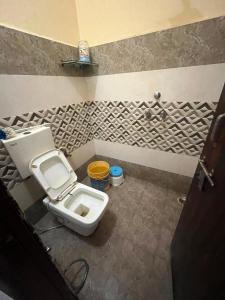 a bathroom with a toilet and a sink at Guru hotel in Sūratgarh
