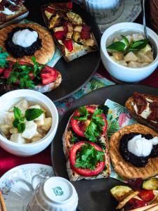 a table with plates of food and bowls of food at Hay barn unique experience Visole in Slovenska Bistrica