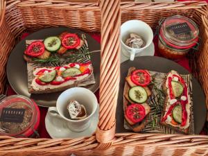 a table with two plates of sandwiches and a cup of coffee at Hay barn unique experience Visole in Slovenska Bistrica +52 photos