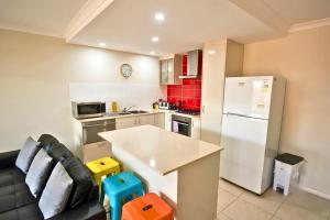 a kitchen with a couch and a white refrigerator at Midland Haven - Midland WA in Midland Junction