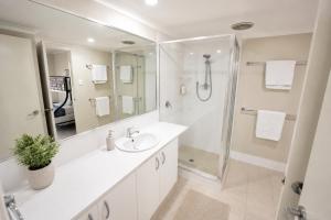 a white bathroom with a sink and a shower at Midland Haven - Midland WA in Midland Junction +13 photos