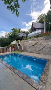 a swimming pool with blue water in front of a house at Tribez Valley Resort in Anaviratty