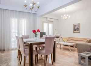 a dining room and living room with a table and chairs at Anastasia in Veria