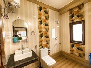 a bathroom with a sink and a toilet at Whispering Meadows Luxury 3BHK Villa in Shimla +37 photos