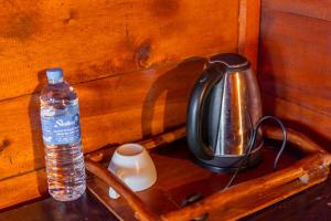 a bottle of water sitting on a wooden drawer at Sinharaja Forest Gate in Deniyaya