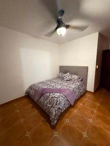a bedroom with a bed and a ceiling fan at Mansion Sublime in Chitré