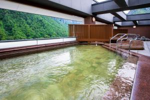 a large pool of water in a room with trees at Choyo Tei in Kamikawa +56 photos