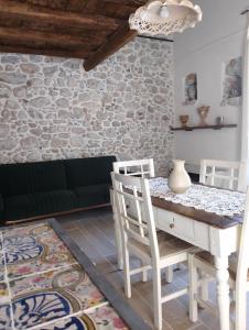 a living room with a table and chairs and a couch at La casetta in Trabia