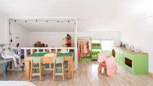 a childs play room with a table and a kitchen at Ganghwa imspa Pension in Incheon