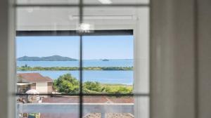a view of a lake from a window at Ganghwa imspa Pension in Incheon +3 photos