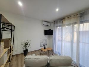 a living room with a couch and a table at STUDIO A 2 MN DE L A75 in Usclas-lʼHérault