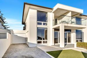 an image of a house with large windows at Sunset Sands on Esplanade By Host Solutions in West Beach