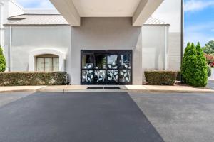 a large white building with a black door at Sleep Inn Chattanooga Hamilton Place in Tyner