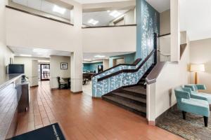 a lobby with a staircase and a blue chair at Sleep Inn Chattanooga Hamilton Place in Tyner