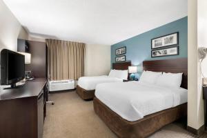 a hotel room with two beds and a television at Sleep Inn Chattanooga Hamilton Place in Tyner +47 photos