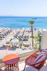 a view of the beach from a hotel room at The Palms Kos in Kos +17 photos