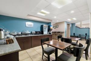 a kitchen and dining room with tables and chairs at Sleep Inn Chattanooga Hamilton Place in Tyner
