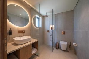 a bathroom with a sink and a shower at The Palms Kos in Kos