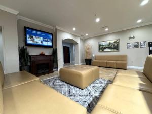 a living room with two couches and a flat screen tv at Quality Inn & Suites McAlester on Hwy 69 in McAlester