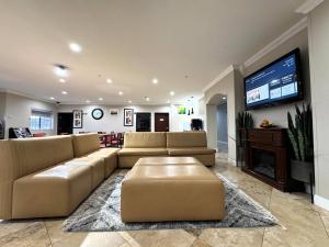 a large living room with couches and a flat screen tv at Quality Inn & Suites McAlester on Hwy 69 in McAlester +87 photos