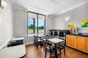 a waiting room with tables and chairs and a counter at Quality Inn in Barbourville