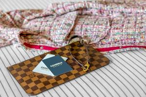 a purse with a tag on it sitting on a bed at Cambria Hotel Jacksonville in Jacksonville
