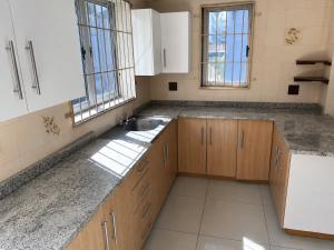 a kitchen with wooden cabinets and a sink at 42 On Canterbury in Durban