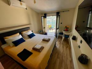 a bedroom with a large bed with blue pillows at Kadena Apartments in Kotor