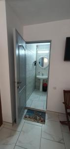 a bathroom with a shower and a toilet and a mirror at Casa Ghemus Costinesti in Costinesti +44 photos
