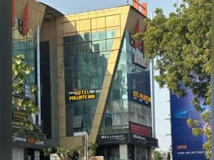 a building with a sign on the side of it at Hotel Palliate Inn in Ahmedabad