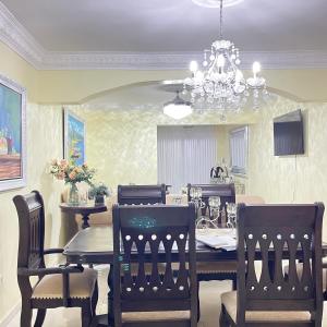 a dining room with a table and chairs and a chandelier at Confortable in San Isidro