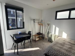a bedroom with a bed and a desk and a table at Sydney Studio with Private Bathroom & Kitchen in Revesby