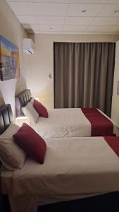 a hotel room with two beds and a window at 85 Palma Living in Victoria