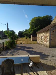 a blue table and a chair sitting on a deck at Meublé Climatisé 75 M2 in Souvans