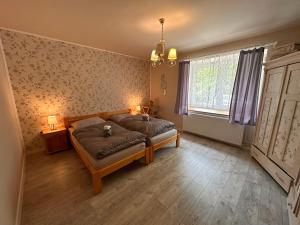 a bedroom with a bed and two lamps and a window at Ubytovanie Lišov 3 - Vidiecky dom in Lišov