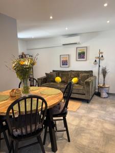 a living room with a table and a couch at Au cocon du verdon, T2 in Gréoux-les-Bains
