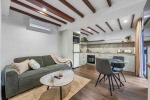 a living room with a couch and a table at Lakes Edge Retreat in Yungaburra