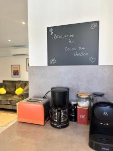 a coffeemaker and a coffee maker and a toaster at Au cocon du verdon, T2 in Gréoux-les-Bains +9 photos