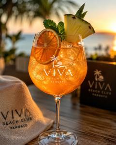 a drink in a glass with an orange slice at Coco Beach Resort in Port Vila