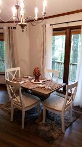 a dining room table with two chairs and a table with a vase at Rustic Tree Top Cabin in Sky Valley, Georgia in Sky Valley