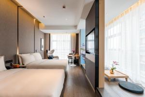 a hotel room with two beds and a window at Atour Hotel Xuzhou CBD in Xuzhou +13 photos