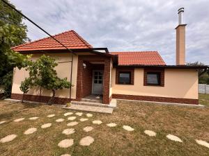 a small house with a grass yard in front of it at Ubytovanie Lišov 3 - Vidiecky dom in Lišov