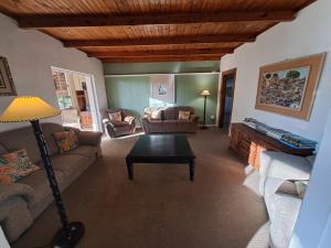 a living room with a couch and a table at Selborne Bed and Breakfast in East London