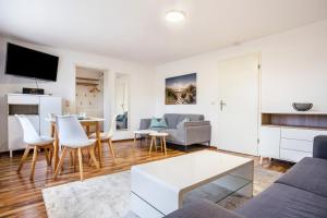 a living room with a couch and a table at Ferienapartment 2 Heimathafen in Seedorf