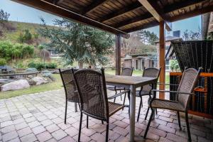a wooden table and chairs on a patio at Ferienapartment 2 Heimathafen in Seedorf